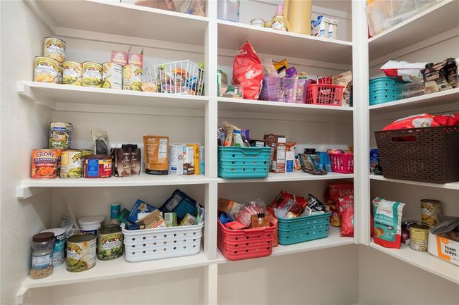 This photo showcases a well-organized pantry with ample shelving and has added bracing in between the shelves. Perfect for keeping your kitchen essentials neatly arranged. | Image 18