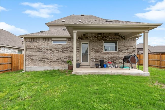 Rear view of property featuring a patio, brick siding, and roof with shingles | Image 35