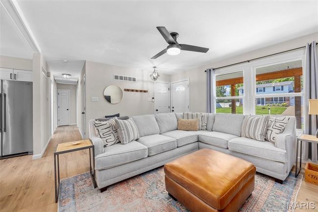 Living room featuring light wood-style floors and a ceiling fan | Image 6