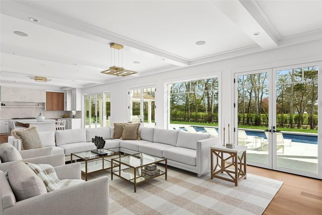 Spacious Living room with double sided gas fireplace and large panel sliding doors to patio | Image 10