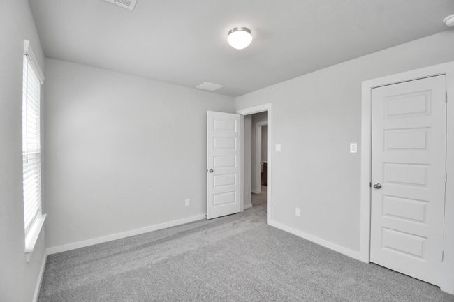 Generously sized secondary bedrooms featuring spacious closets, soft and inviting carpeting underfoot, large windows allowing plenty of natural light, and the added touch of privacy blinds for your personal retreat. | Image 32