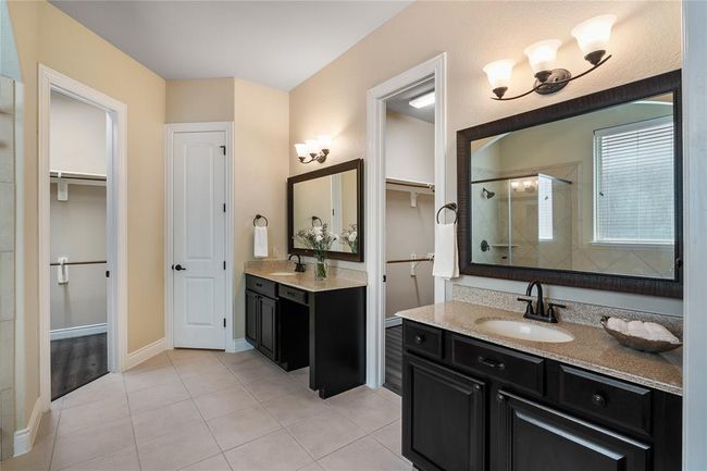 Elegantly appointed double sinks, as well as His and Her own closet. | Image 21
