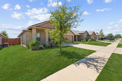 Ranch-style home featuring a front yard and central AC | Image 3