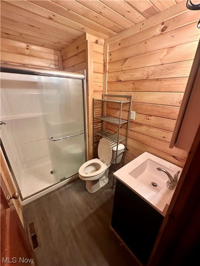 Bathroom with wood ceiling, vanity, an enclosed shower, wood-type flooring, and toilet | Image 12
