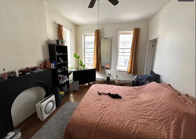 Bedroom featuring ceiling fan and dark wood-style flooring | Image 6