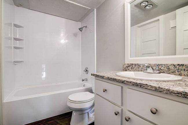 Bathroom featuring shower / bath combination, vanity, toilet, and wood finished floors | Image 14