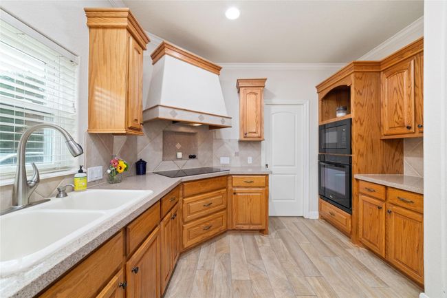 Kitchen with huge island with breakfast bar. | Image 18