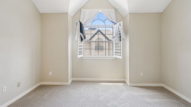 Carpeted empty room featuring baseboards and vaulted ceiling | Image 19