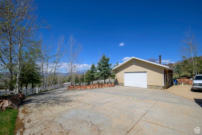 View of property exterior with fence and a garage | Image 5