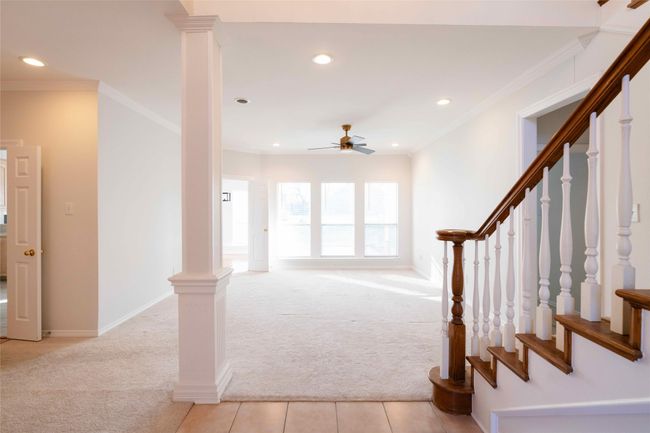 Foyer entrance featuring light colored carpet, ceiling fan, stairs, ornamental molding, and recessed lighting | Image 10