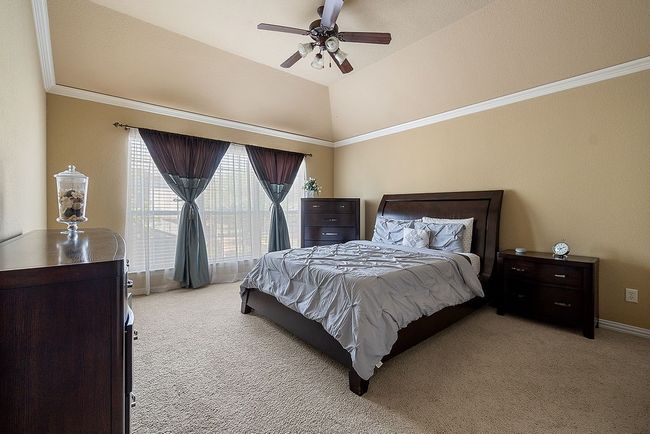 Bedroom with baseboards, ceiling fan, carpet floors, and crown molding | Image 12