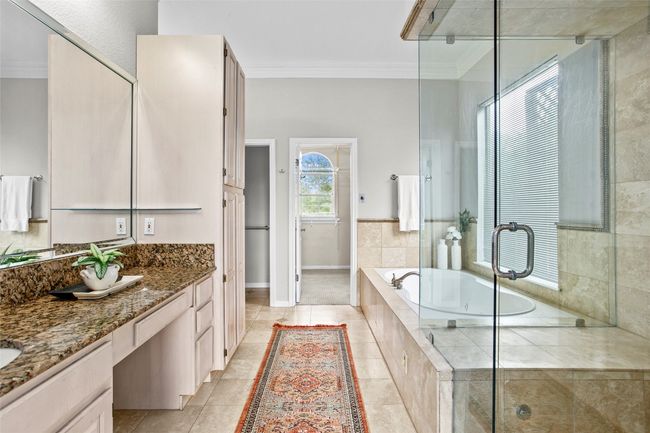 Primary bathroom with double vanities and large walk in closet | Image 17