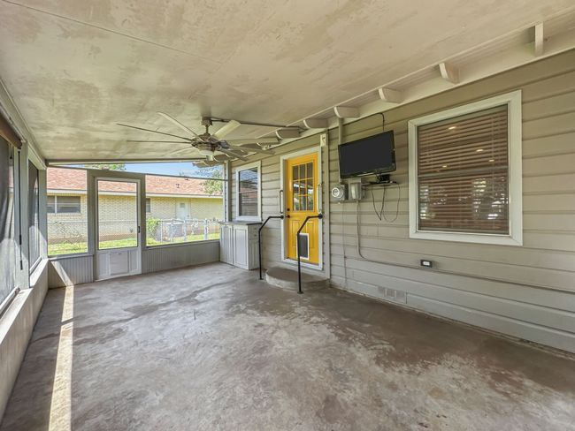 Unfurnished sunroom featuring a ceiling fan | Image 15