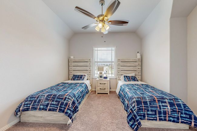 Bedroom featuring baseboards, vaulted ceiling, ceiling fan, and carpet floors | Image 19