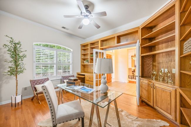 The study features custom built-ins, including a spacious desk and dedicated file drawers—ideal for a productive home workspace. | Image 22