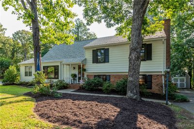 Split level home with a front lawn and a shed | Image 3