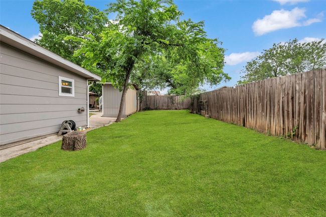 View of yard featuring an outdoor structure, a fenced backyard, and a shed | Image 7