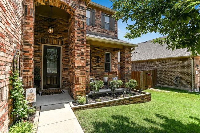 Property entrance with brick siding and a porch | Image 36