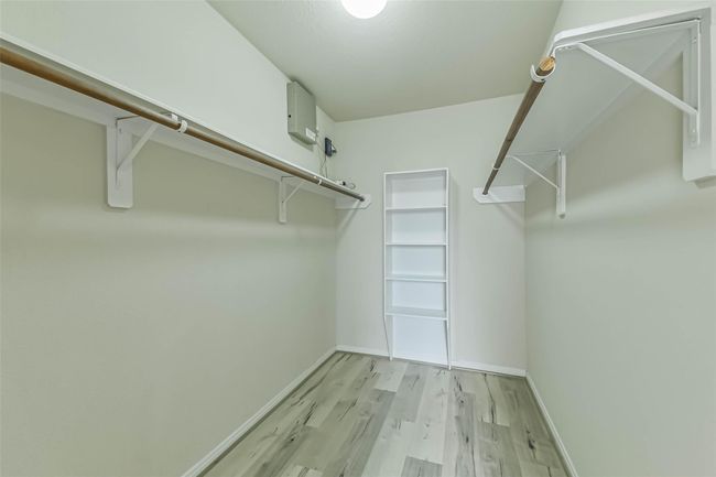 An expansive Primary closet...features custom built-ins and abundant shelving to keep everything organized and within reach. | Image 23