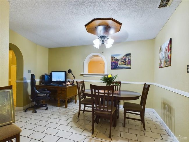 Tiled dining room with a textured ceiling and ceiling fan | Image 12
