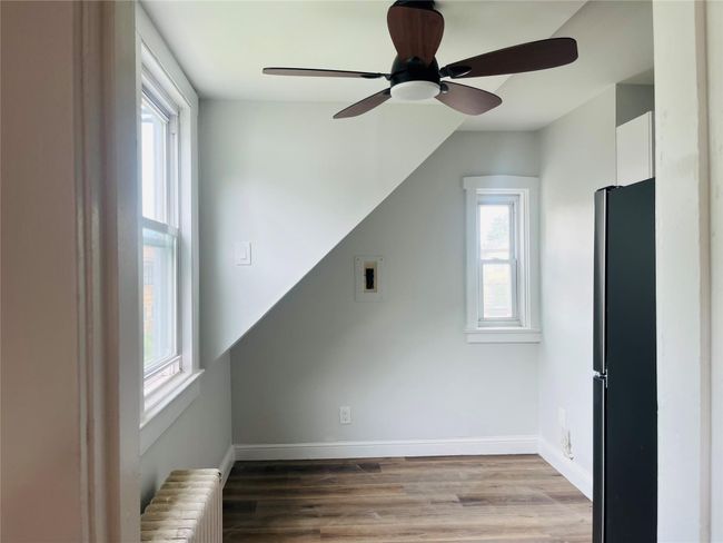 Spacious kitchen with natural light, and ceiling fan | Image 6