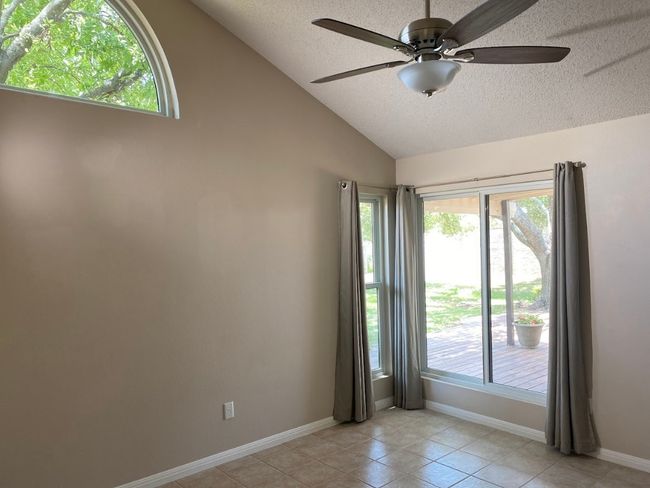 Primary bedroom is also full of natural light with multiple windows looking out into the private backyard. | Image 7