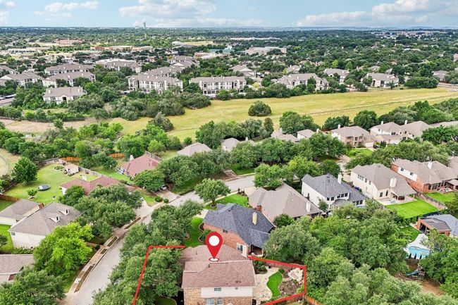 Situated on a spacious lot in a serene, tree-lined neighborhood. | Image 34