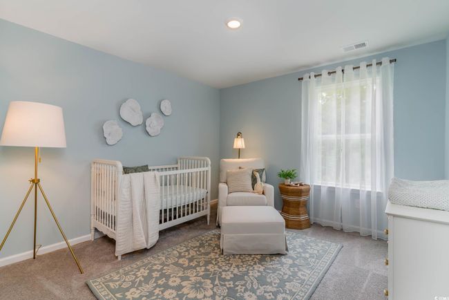 Carpeted bedroom featuring a crib and baseboards | Image 23