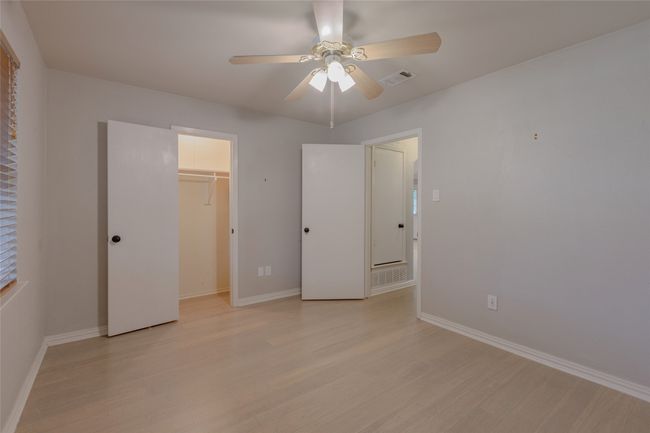 Unfurnished bedroom with light wood finished floors, a ceiling fan, and a closet | Image 22