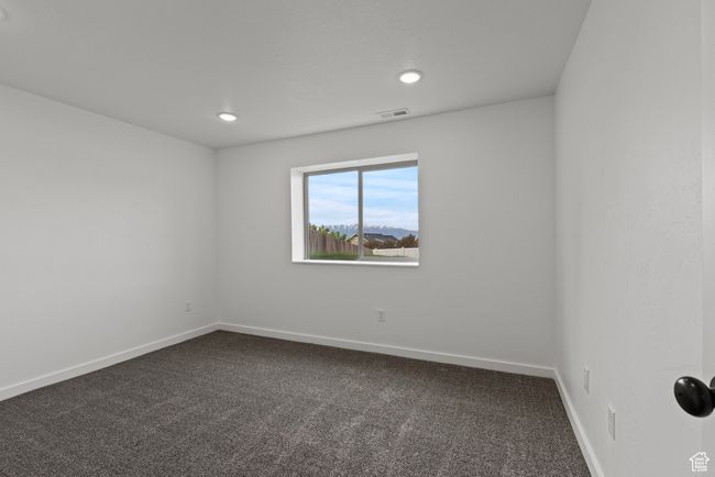 Unfurnished room featuring dark carpet, baseboards, and recessed lighting | Image 32