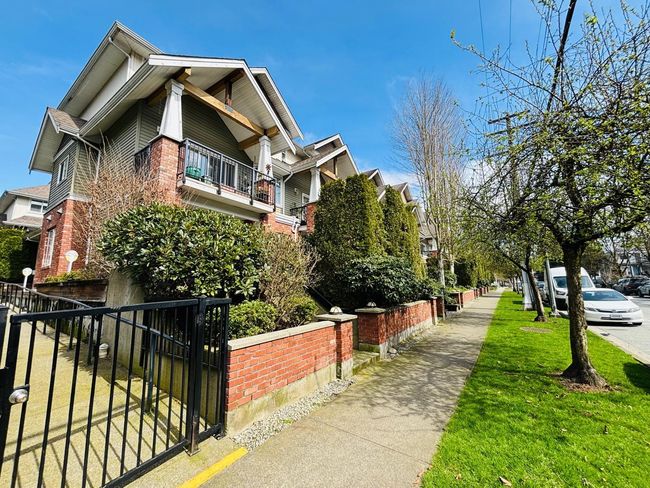 View of property exterior featuring brick siding and a balcony | Image 32