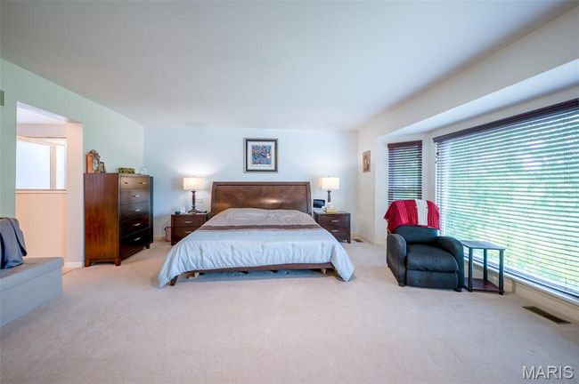 Bedroom featuring light carpet and multiple windows | Image 27