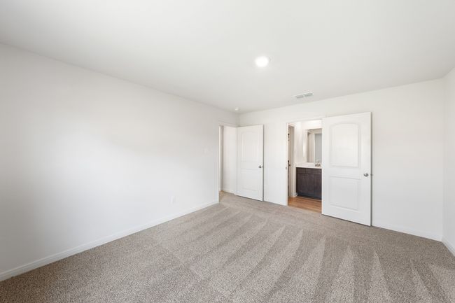 Bedroom with carpet floors and ensuite bath | Image 5