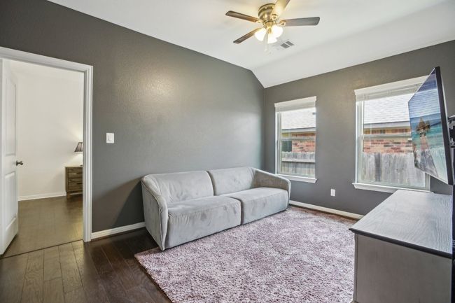Living room featuring dark wood finished floors, vaulted ceiling, and ceiling fan | Image 24