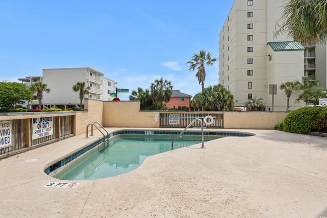 View of pool with a pool, fence, and a patio area | Image 36