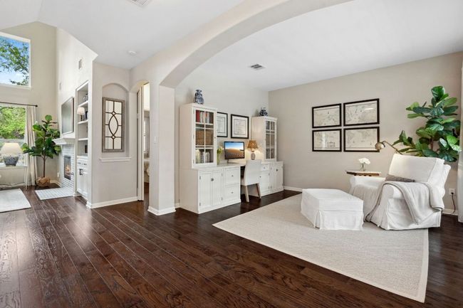 A sweeping archway off the entry foyer opens into a formal living room with excellent flexibility for use of space. | Image 14