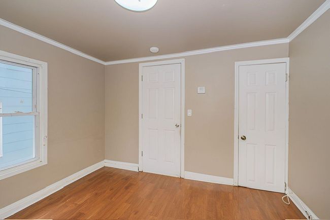 Unfurnished room featuring wood finished floors and ornamental molding | Image 6
