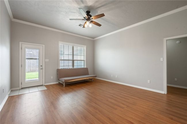 Unfurnished room with light wood-type flooring, ceiling fan, crown molding, and baseboards | Image 6