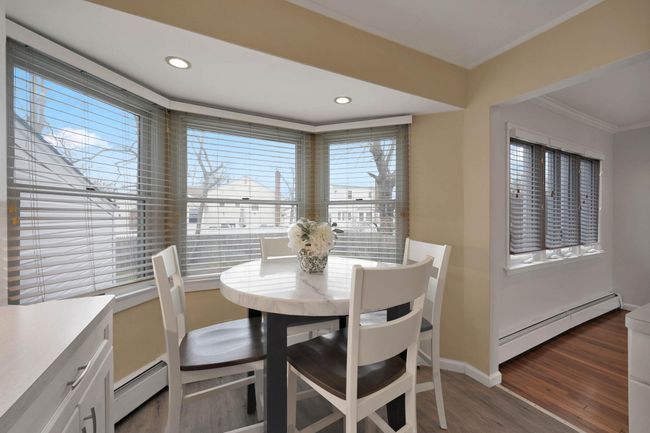 Dining space with ornamental molding, a baseboard radiator, and dark hardwood / wood-style floors | Image 9