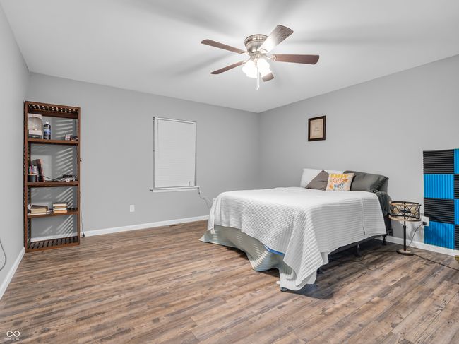 Spacious primary bedroom with vinyl plank flooring. | Image 12