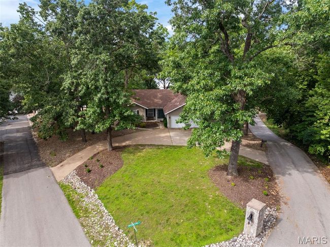 View of front facade with a garage, a front yard, and driveway | Image 38
