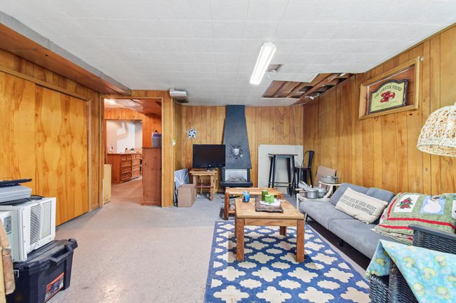 Living area featuring wood walls | Image 28