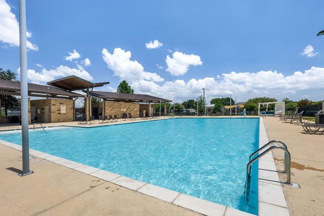 Community pool features lots of seating. | Image 28