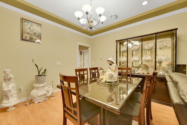 Dining space with a chandelier, light wood-style flooring, ornamental molding, and baseboards | Image 39