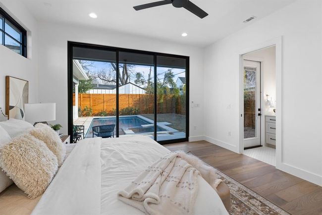 Bedroom with access to outside, multiple windows, wood finished floors, and recessed lighting | Image 31