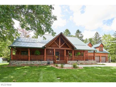 Log-style house with a 3 garage, a relaxing front porch on 1.38 acres | Image 2