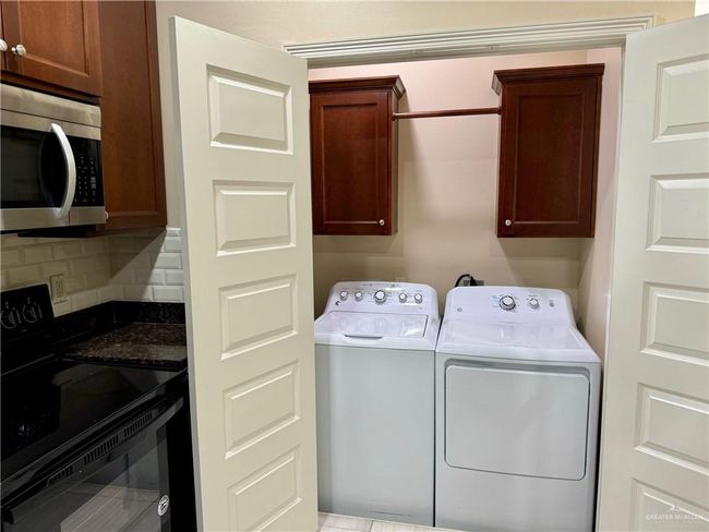 Laundry area with cabinets and washer and dryer | Image 6