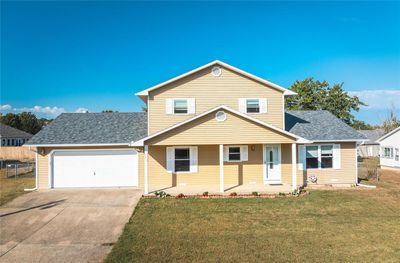 Front of property with a garage and a front lawn | Image 1