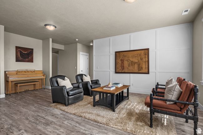 Living area featuring baseboards, wood finished floors, and visible vents | Image 6