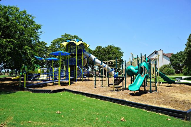 Community playground featuring a yard | Image 31